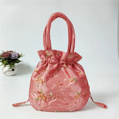 Sac à main bourse en satin avec broderies florales